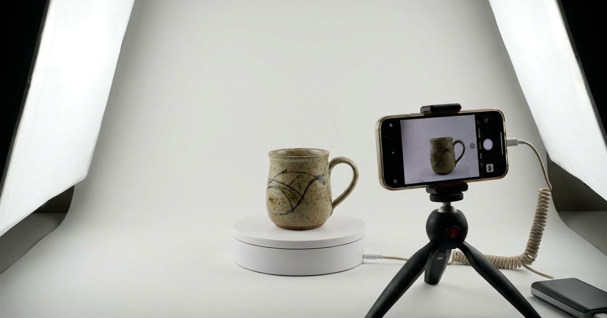 Handmade ceramic mug on a small turntable being photographed from several angles to build a 360 product spin GIF